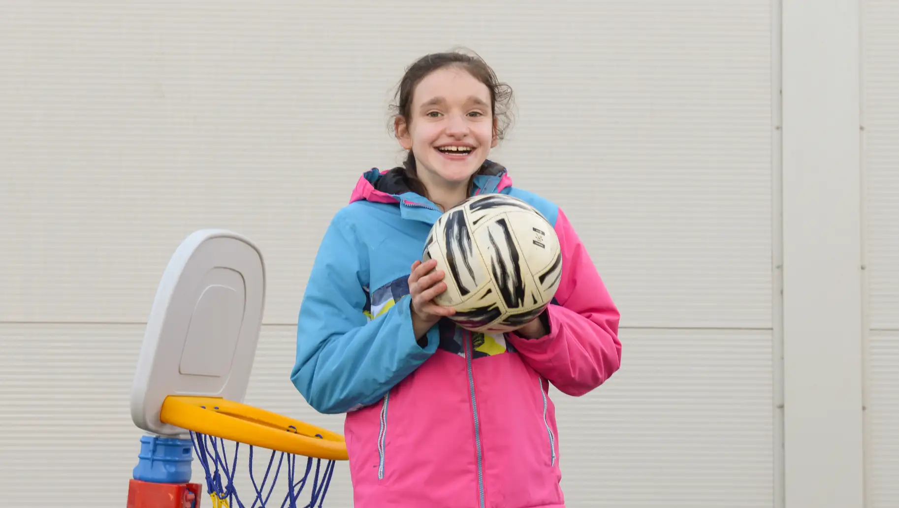 Young girl playing with a football