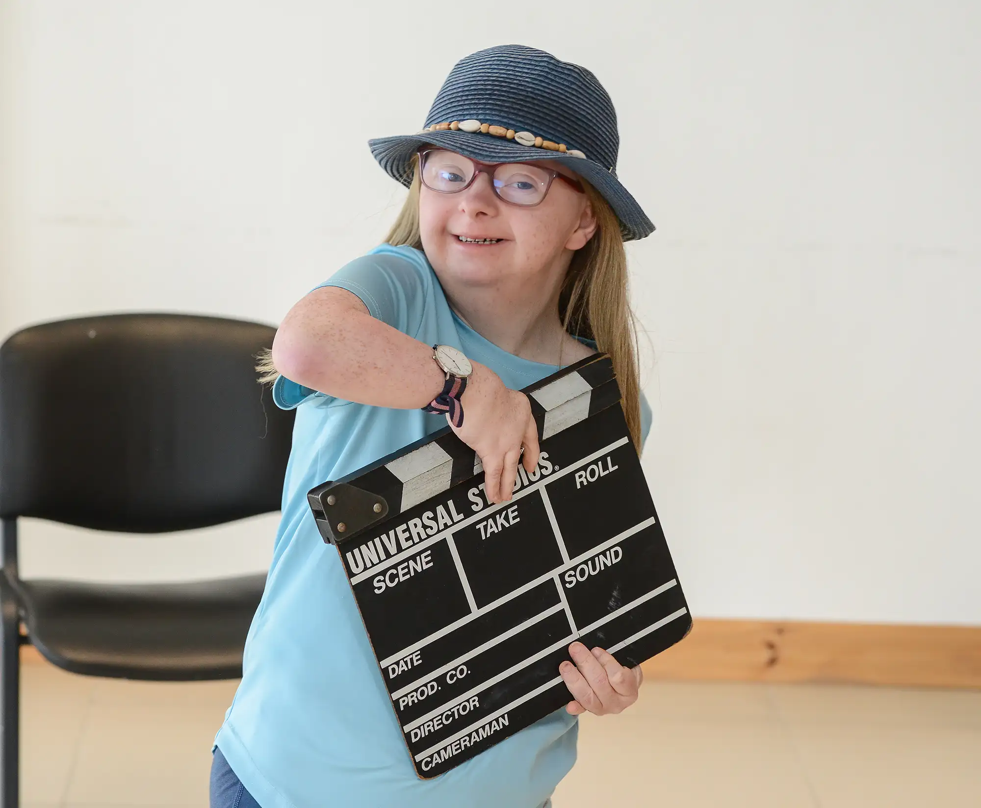 Young person holding a directors clapper