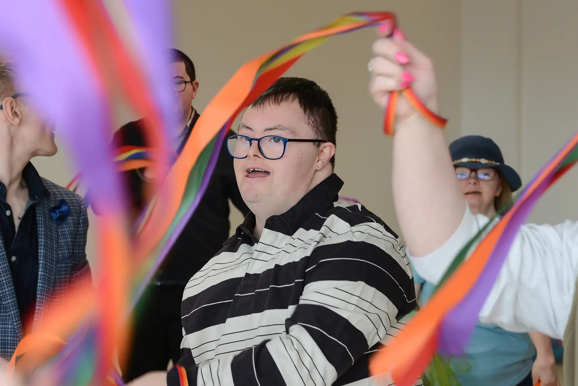 young man dancing with a group of young people
